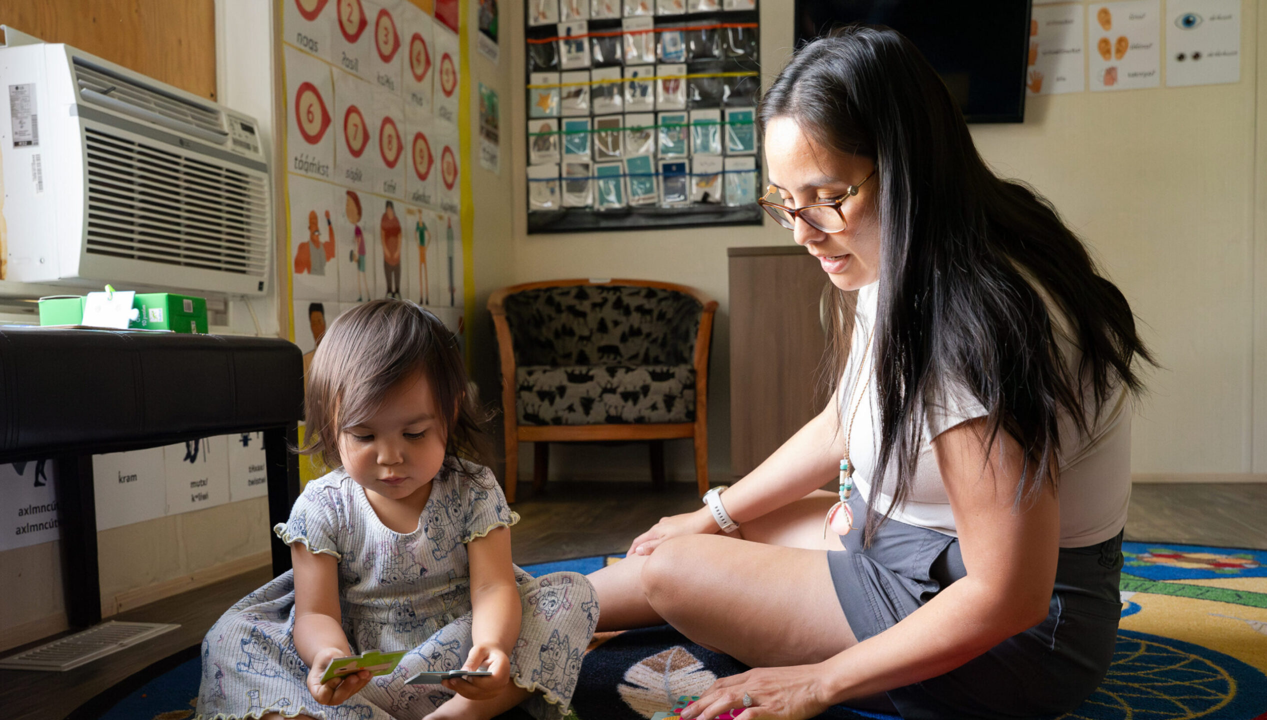 Monika Alexis, Nsyilxcən Language Instructor, speaking with her daughter in the language nest.